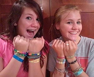Teens model their event wristbands Teens model their event wristbands